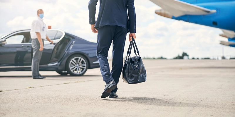 cropped photo successful businessman carrying duffel bag headed towards taxi
